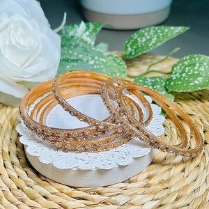 Brilliant Crystal and gold tone layered over clear acrylic Bangle Bracelet